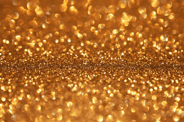 Wall Mural - Golden glitter festive bokeh background, abstract defocused texture. Holiday lights