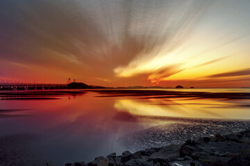 Wall Mural - Sunset view of Yeongjong Bridge on sea with tidal channel and mud flat at low tide near Jeongseojin, Incheon, South Korea 