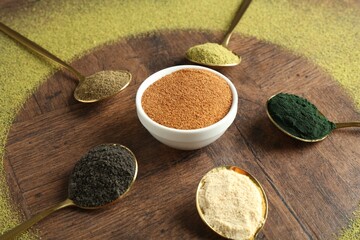 Poster - Different superfood powders in spoons and bowls on wooden table