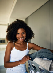 Wall Mural - Black woman, portrait and laundry basket in home with smile for spring cleaning, routine and hygiene. Person, happy and container with washing clothes for dirt, fabric and start housework in Kenya