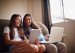 © StarDweller/peopleimages.com - Woman, teenager and technology in living room for bonding, e learning and streaming as family. People, happiness and internet for education, development and homework as mother and daughter in home