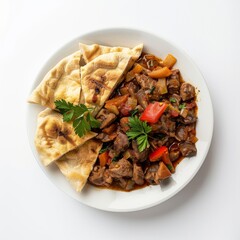 Sticker - A white plate with a savory meat stew and flatbread.