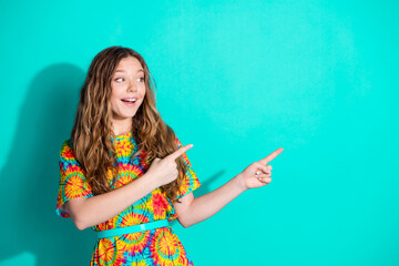 Photo portrait of attractive teen woman point look empty space dressed stylish colorful clothes isolated on cyan color background