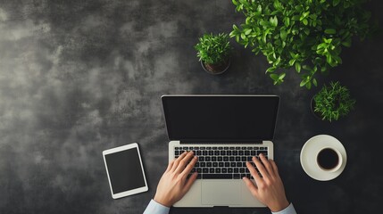 Poster - A person typing on a laptop in a cozy workspace with plants, coffee, and a tablet near a window during daylight