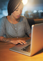 Business woman, night and computer in office for working overtime, deadline and creative online project. Female graphic designer, laptop and research for font choice, website layout and ui software