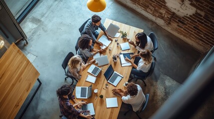 Poster - Team collaboration session at a modern office with multiple laptops and creative brainstorming on a large wooden table