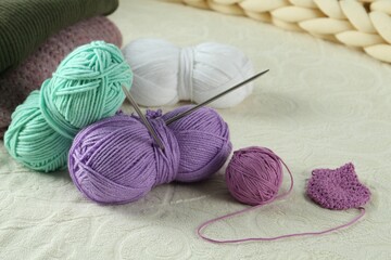 Sticker - Bright yarns, pattern sample and knitting needles on soft blanket