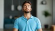 © Vee - A young man practices mindfulness and meditation in a modern living space, promoting relaxation and mental clarity.
