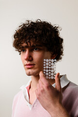 using acne stickers to create a moist environment to clean face from zits faster. man is taking care