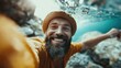 © JoxyAimages - A joyful, bearded man captured smiling underwater, wearing a knitted cap and radiating happiness and adventure, embodying a fun and carefree lifestyle.