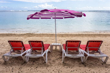 Wall Mural - Parasol et transats rouges sur plage de l’Hermitage, île de la Réunion 