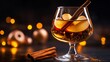 © fivan - A glass of warm apple brandy with a cinnamon stick, set against a deep black background with glowing orange accents