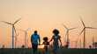 © Montri - family looking windmills. African American family in the community with wind generators turbines, Wind turbines are alternative electricity sources, sustainable resources and Renewable energy.