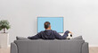 © Ljupco Smokovski - Man football fun sitting on a sofa in front of tv