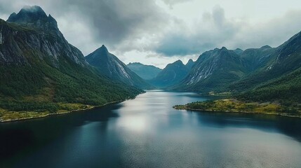 Poster -   Surrounded by green trees and towering peaks, a serene body of water lies in the heart of this valley