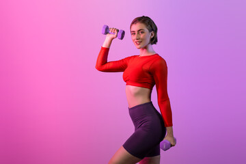 Wall Mural - Full body length gaiety shot athletic and sporty woman with dumbbell for weight lifting as bodybuilding exercise in standing posture on isolated background. Healthy active and body care lifestyle