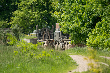 Wall Mural - large dark green utility vehicles parked in a woodland hamlet