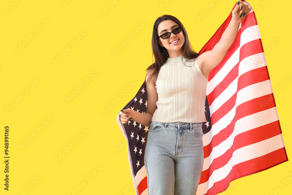 Young woman with USA flag on yellow background