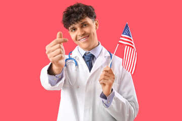 Wall Mural - Male doctor with USA flag making heart shape on red background