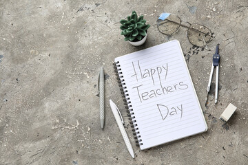 Wall Mural - Notebook with text HAPPY TEACHERS DAY, eyeglasses and different stationery on grunge grey background