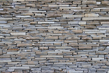 Light brown and grey stone wall with empty space in between. Beautiful stone pattern, background. Wallpaper