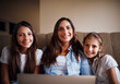 © StarDweller/peopleimages.com - Woman, kids and portrait with laptop in home or streaming, e learning and bonding as family. People, happiness and technology for education, development and homework as mother and daughter in lounge