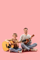 Canvas Print - Private music teacher and little boy with guitars sitting on pink background