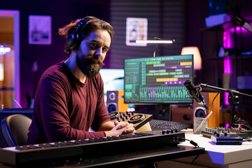 Aufkleber - Portrait of artist producer playing midi controller notes and adding them on new song, using daw software interface to mix and master tunes. Skilled musician creating music with piano keys.
