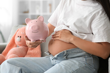 Poster - Young pregnant woman with piggy bank sitting on sofa at home, closeup. Maternal Benefit concept