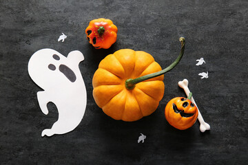 Wall Mural - Halloween composition with ripe pumpkins and decorations on dark background