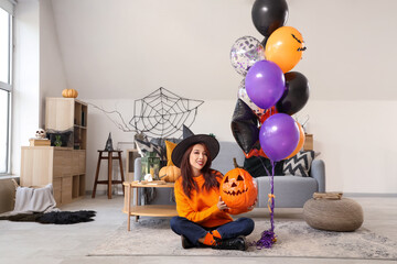 Poster - Young Asian woman in witch hat with Halloween pumpkin and balloons at home