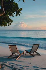 Wall Mural - Two lounge chairs on a sandy beach next to the ocean, perfect for relaxation