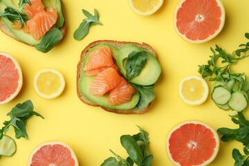 Poster - A delicious breakfast features avocado toast topped with salmon, fresh citrus slices, and greens, all set against a bright yellow background. Generative AI