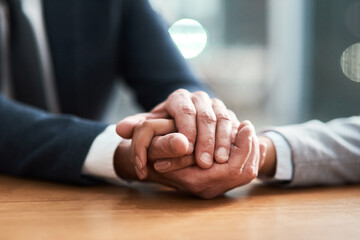 Poster - Business people, holding hands and closeup in office for empathy, support and grief counseling in HR. Solidarity, partners and gesture at table for compassion, understanding and trust in workplace