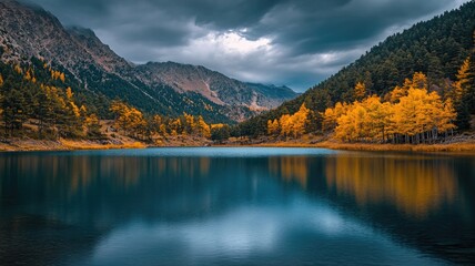 Wall Mural - serene mountain lake with autumn trees reflecting in clear water beneath stormy sky