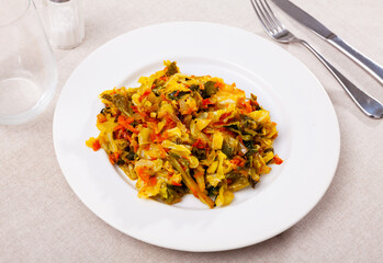 Sticker - Fresh portion of braised cabbage served on plate. Stewed vegetables.