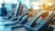 © PaulShlykov - close up soft focus on telephone devices with copy space background at office desk in operation room for customer service support (call center) concept.