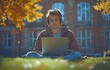 © tongpatong - Young man working as a freelancer and a student, wearing headphones while using a laptop to work remotely and study outside