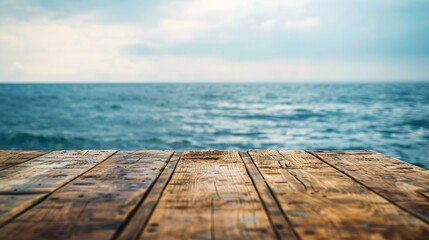 07231249 169. Crisp wooden table edge with a gently blurred ocean landscape beyond, emphasizing the calm and expansive nature of the sea