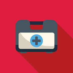 Canvas Print - Closed first aid kit is lying flat on a red background, casting a long shadow