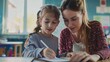 © liliyabatyrova - A woman is helping a young girl write in a notebook