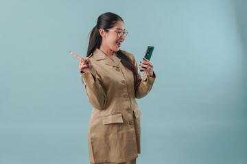 Wall Mural - Pretty government worker woman holding smartphone while pointing to the copy space behind her.