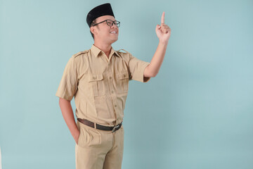 Excited Indonesian government worker man wearing khaki uniform giving number one by hand gesture.