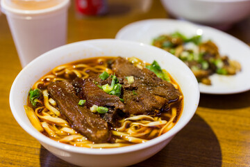 Sticker - Taiwanese spicy red soup beef noodle in bowl