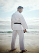 © peopleimages.com - Warrior, karate and man at beach for exercise, training or thinking of martial arts outdoor. Fighter, person or practice taekwondo at ocean for fitness, sport or workout body with back view in summer