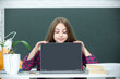 © Volodymyr - The school. Teen girl school student with laptop at school. Teenager Student Working On Laptop in classroom. Little girl using laptop, study online on computer. Homeschooling concept. School lesson.