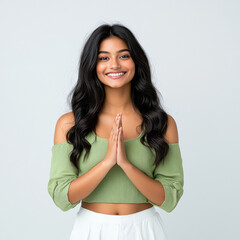 Canvas Print - Young indian woman standing on white background and doing namaste or welcome gesture