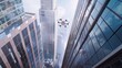© PuiZera - Drone flying between skyscrapers in a city.