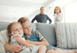 © KayJoint/peopleimages.com - Family, parents fight and girls comfort on sofa with hug from divorce, conflict and custody discussion. Sad, home and stress of kids from marriage crisis and situation with sister love and support