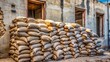 © Wanlop - a photo image of old, weathered construction cement bags stacked haphazardly on a dusty building site
